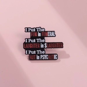 Detail of enamel pin with humorous slogans on a soft pink background and soft shadows