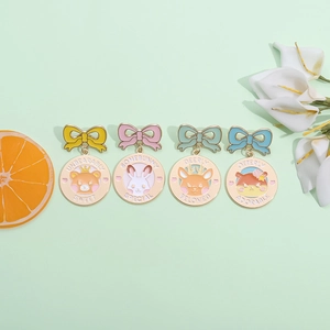 Cute cartoon animal enamel brooch set with ribbons and charms on a soft mint background