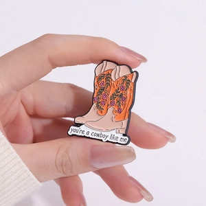 Colorful cowboy boot enamel pin with floral patterns and you are a cowboy like me text