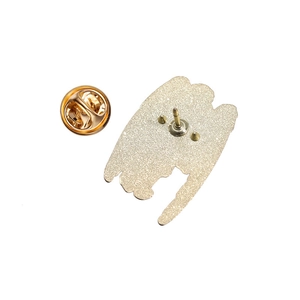 Close-up of gold-plated enamel pin back with sandblast texture and butterfly clutch closure