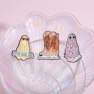 Three-piece Taylor Swift inspired enamel pins with ghost and cowboy boot designs