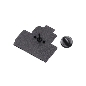 Close-up of the black metal brooch back with sandblasted texture and rubber clutch
