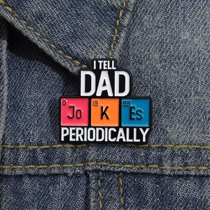 Close-up of Periodic Table Dad Joke enamel pin on a blue denim jacket collar