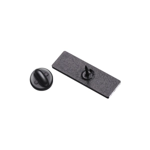 Detail view of durable black alloy brooch backing with secure clutch needle and matte finish