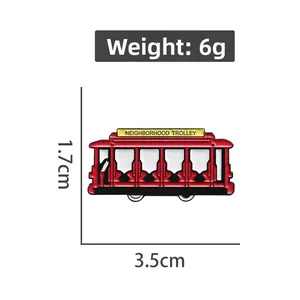 Macro shot of red enamel trolley brooch with size dimensions and vintage details