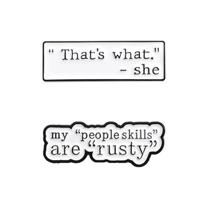 Minimalist white enamel pins set with inspirational quotes in geometric speech bubbles