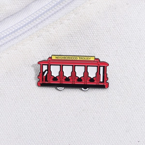 Detail of red enamel trolley pin with Neighborhood Trolley text on canvas background