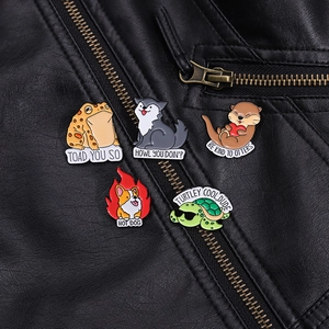 Detailed view of animal enamel pins on a leather jacket with witty puns and vibrant colors