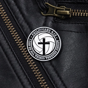 Macro detail of volleyball badge with Philippians 4:13 verse on black leather jacket