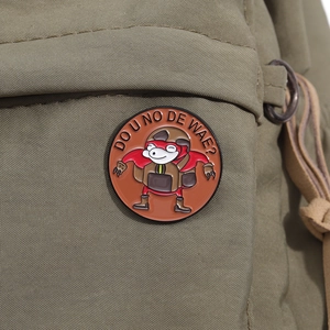Close-up of a round enamel pin on green canvas bag featuring Do You Know The Way design