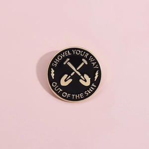 Round enamel shovel badge pin with gold finish and Shovel Your Way Out Of The Shit text