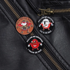Macro view of three enamel meme badges featuring cartoon characters on a black leather jacket