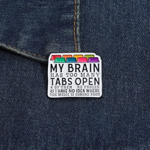 Close-up of funny browser tab enamel pin on blue denim fabric showing clever graphic detail