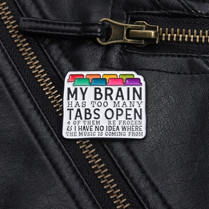 Close-up of a colorful file folder enamel pin pinned on a black leather jacket