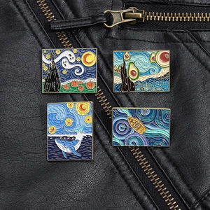 Detailed view of four artistic enamel pins featuring Van Gogh style motifs on black leather