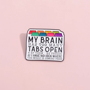 Creative folder shaped enamel pin with colorful browser tabs on a soft pink background