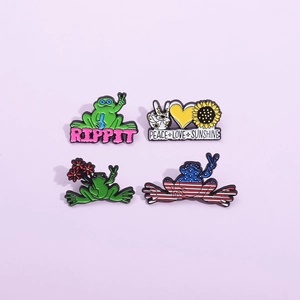 Set of 4 creative enamel pins featuring green frogs, sunflowers and peace love sunshine motifs