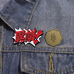 Detailed view of Ace Attorney enamel pins featuring Igiari bubble on blue denim jacket
