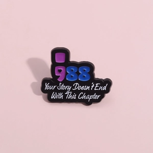 Enamel lapel pin with 988 numbers and Your Story Doesn't End With This Chapter text