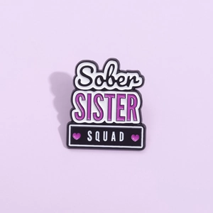 Enamel brooch with Sober Sister Squad lettering and purple hearts on metal pin