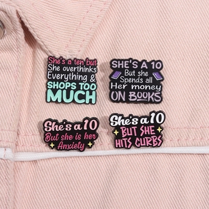 Set of 4 creative enamel coffee badges with motivational funny quotes on pink corduroy fabric