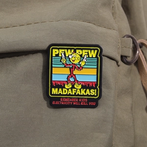 Enamel pin on a canvas bag showing a cartoon character with Pew Pew Madafakas text