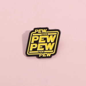 Enamel pew pew pin in yellow and black sci-fi style on a light pink background