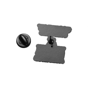 Detailed back view of enamel pin with sharp needle and black rubber clutch backing