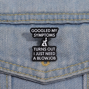 Funny enamel pin with adult humor text pinned on a stylish denim jacket fabric