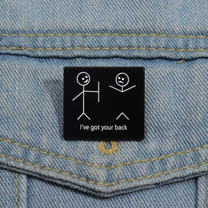 Funny square enamel brooch with I've got your back slogan on denim jacket pocket