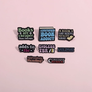 Set of 8 colorful metal enamel pins featuring inspirational reading quotes and book designs