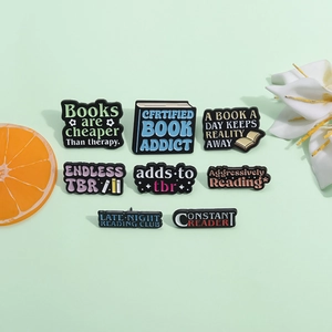 Set of 8 bookish enamel pins with motivational reading quotes on a green background