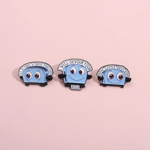 Three-piece set of cartoon blue toaster enamel pins featuring creative English lettering