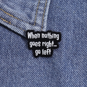 Detailed macro view of a humor enamel pin on denim jacket with the quote When nothing goes right