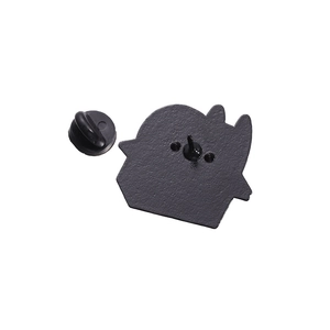 Close-up of matte black metal enamel pin back with secure black rubber clutch backing