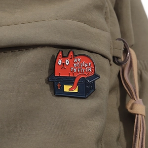 Close-up of funny cat in a box enamel pin on canvas bag featuring slogan No Desire To Fit In