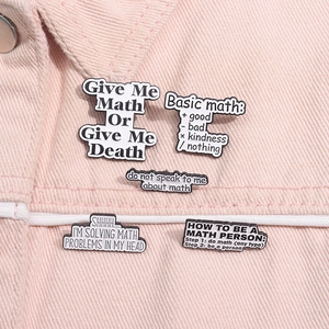 Detailed close-up of funny math quote enamel pins set on pink denim jacket background