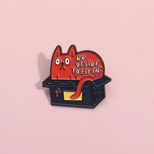 Creative enamel cat brooch featuring a red kitten in a black box with inspiring quote
