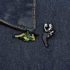 Detail of vintage horror enamel pins featuring monster and gothic woman on denim jacket