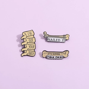 Three-piece set of cartoon medical skeleton enamel pins on a lavender background
