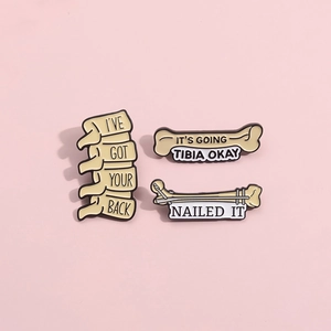Three-piece set of cartoon bone enamel pins with medical puns on pink background