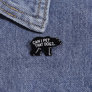 Funny black bear enamel pin with Can I Pet That Dog text on denim fabric background