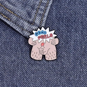 Macro shot of Good Feels enamel pin with funny legs and hand gesture on blue denim
