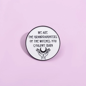 Feminist enamel pin with phrase We Are The Granddaughters Of The Witches You Couldn't Burn