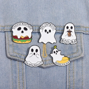 Detailed close-up of cute Halloween ghost enamel pins on a denim jacket pocket
