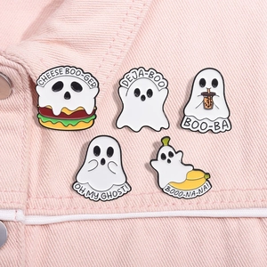 Detail of five creative cartoon ghost enamel pins on pink denim fabric background