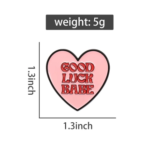 Pink heart enamel pin measuring 1.3 inches with Good Luck Babe text and 5g weight