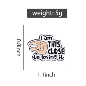 Detail view of the enamel pin showing 1.1x0.8 inch dimensions and 5g weight on white background