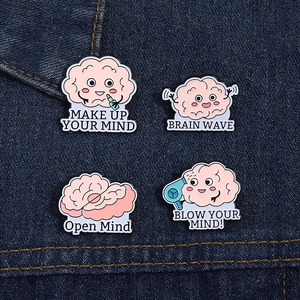 Close-up of funny enamel brain pins set on denim, featuring creative cartoon mental designs