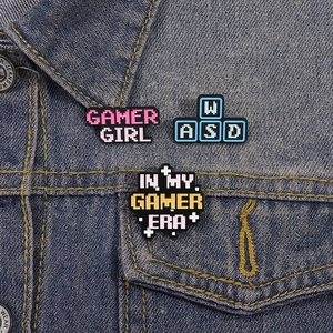 Creative enamel gamer pins set featuring Gamer Girl and WASD icons on denim jacket